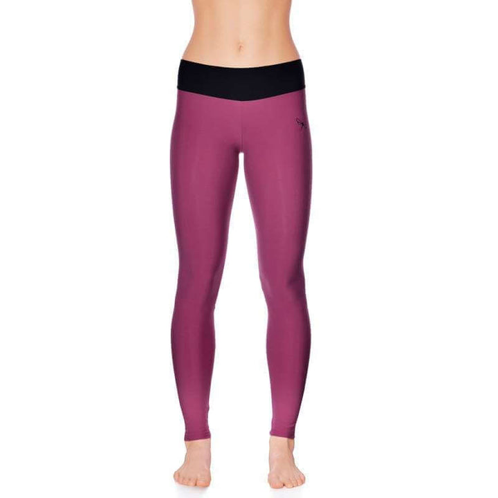Mid rise leggings in a vibrant plum color with black waistband for comfortable yoga and movement.