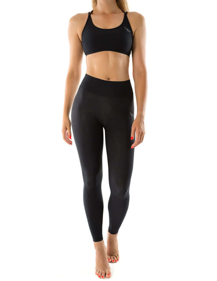 Mid rise leggings worn by a model, showcasing their sleek design and comfortable fit for yoga and exercise.