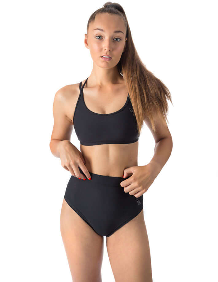 Model wearing scrunch bum pole shorts and a matching top, demonstrating high waist fit and stylish design.